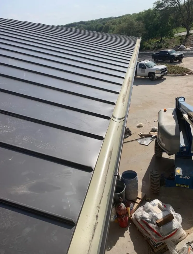 Standing seam panel and gutter detail on a metal roofing jobsite in Liberty Lake